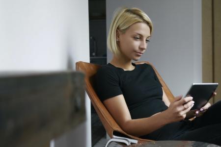 A woman using Splashtop remote desktop software on her Android tablet.